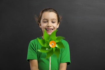 Image showing Little girl holding a windmill