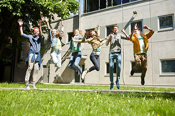 Image showing happy teenage students or friends jumping outdoors