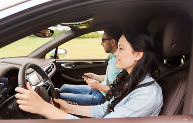 Image showing happy man and woman driving in car