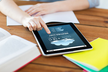 Image showing close up of student with tablet pc and notebook