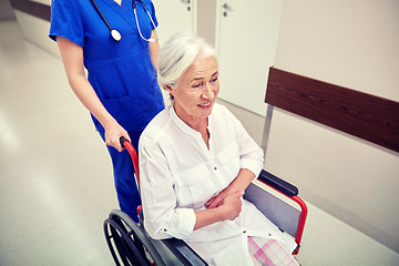 Image showing nurse with senior woman in wheelchair at hospital