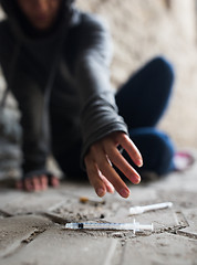 Image showing close up of addict woman reaching to drug syringes