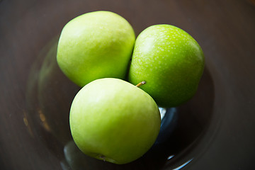 Image showing close up of green apples on glass plate