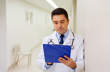 Image showing doctor writing to clipboard at hospital