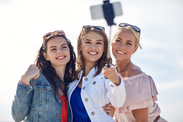 Image showing group of smiling women taking selfie on beach