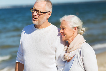 Image showing happy senior couple hugging on summer beach