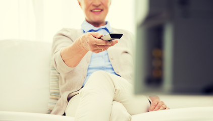 Image showing close up of happy senior woman watching tv at home