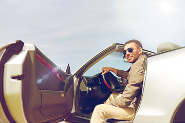 Image showing happy man opening door of cabriolet car outdoors