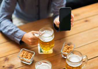 Image showing close up of friends with smartphone and beer