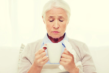 Image showing sick senior woman drinking hot tea at home