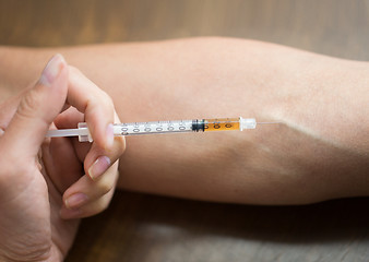 Image showing close up of addict hand making drug injection