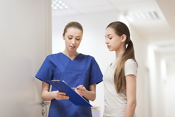 Image showing doctor or nurse with clipboard and girl patient