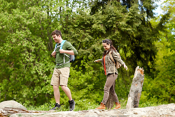 Image showing happy couple with backpacks hiking outdoors