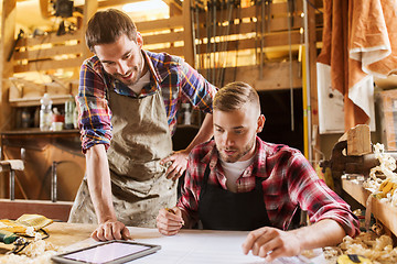 Image showing workmen with tablet pc and blueprint at workshop