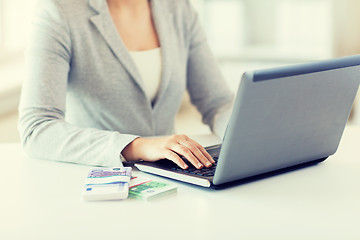 Image showing close up of woman hands with laptop and money