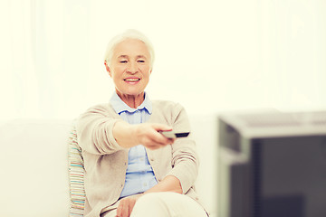 Image showing happy senior woman watching tv at home