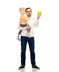 Image showing happy father and little son with green apple