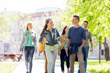 Image showing group of happy teenage students walking outdoors