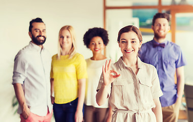 Image showing happy woman showing ok over creative office team