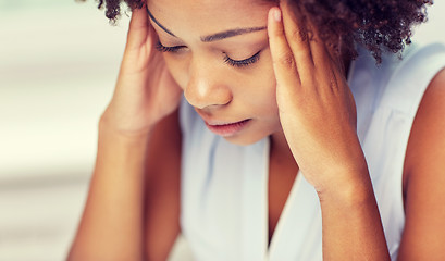 Image showing close up of african young woman touching her head