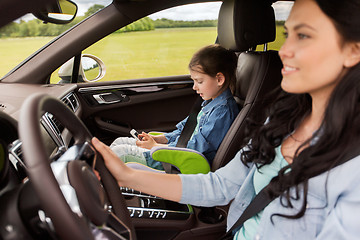 Image showing happy woman with little child driving in car