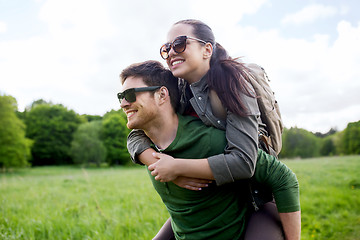 Image showing happy couple with backpacks having fun outdoors