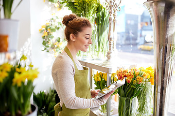 Image showing woman with tablet pc computer at flower shop