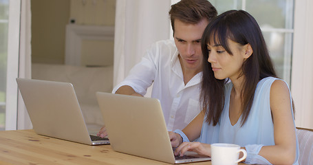 Image showing Man and woman working on laptop computers together