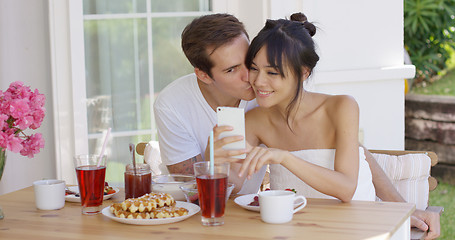 Image showing Happy mixed race couple taking selfie