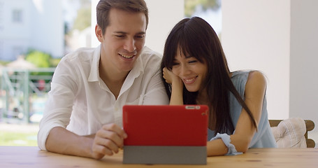 Image showing Smiling couple using a tablet computer together