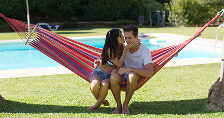 Image showing Loving couple in hammock kissing each other