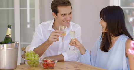 Image showing Cheerful couple toasting champagne