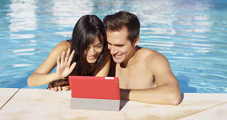 Image showing Couple communicates with friends on digital device