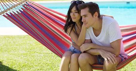 Image showing Affectionate young couple sitting on a hammock