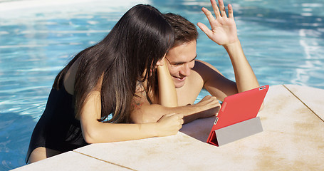 Image showing Handsome couple with portable digital device