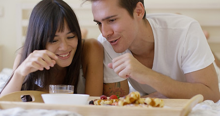 Image showing Couple having fruit and waffle breakfast in bed