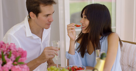 Image showing Couple sipping wine and eating fruit