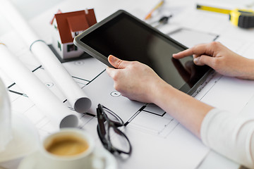 Image showing close up of hand with blueprint and tablet pc