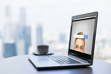 Image showing close up of laptop and coffee cup on office table