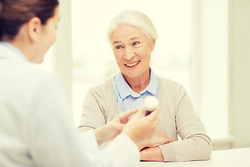 Image showing doctor with medicine and senior woman at hospital