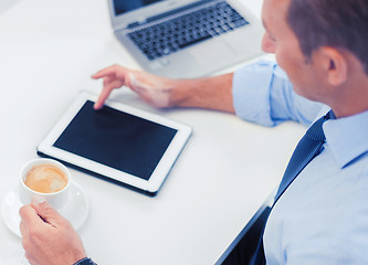 Image showing businessman with tablet pc and coffee in office