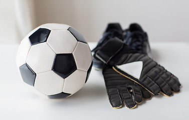 Image showing close up of soccer ball, boots and gloves on table