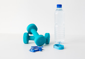 Image showing dumbbells, fitness tracker, earphones and bottle