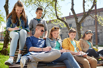 Image showing group of students with notebooks at school yard