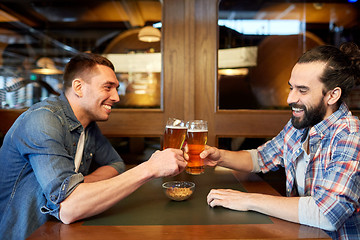 Image showing happy male friends drinking beer at bar or pub