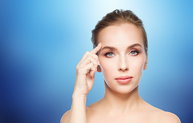 Image showing beautiful young woman showing her forehead