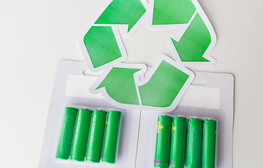 Image showing close up of batteries and green recycling symbol