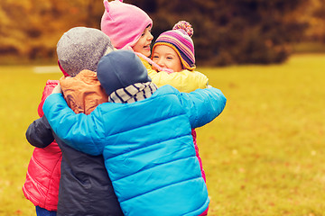 Image showing group of happy children hugging in autumn park