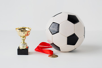 Image showing close up of football ball, golden cup and medal