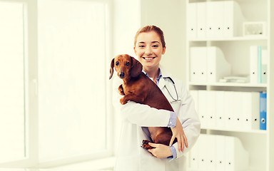 Image showing happy doctor with dog at vet clinic